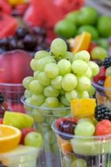 Mixed fruit salad with strawberry, watermelon, fig, cherry and grape. Selective focus of fruits. Veritcal fruit background wallpaper.
