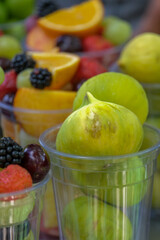 Mixed fruit salad with strawberry, watermelon, fig, cherry and grape. Selective focus of fruits. Veritcal fruit background wallpaper.