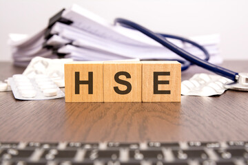 HSE Health and Safety Executive text on wooden blocks. medical concept. - obrazy, fototapety, plakaty