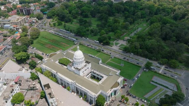 Aerial view of beautiful white historic building of town hall. Multilane road and large park surrounding seat of Municipal Council Colombo, Sri Lanka