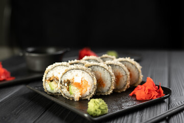 Hot fried sushi roll with salmon, avocado, eel and cream cheese. Sushi menu. Japanese food concept.