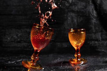 two wine glasses with splshing of wine