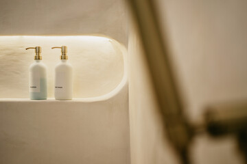 Selective focuse of Pump glass bottle with Liquid soap, shampoo, bath foam and accessories in bathroom