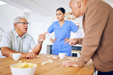 Nurse, senior and fighting over a game of dominoes with people in a retirement home for assisted...