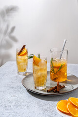 Fresh cocktail with orange, ice and herbs on the  table. Refreshing drink on a hot summer day. Ice tea. Sangria or punch in a glass
