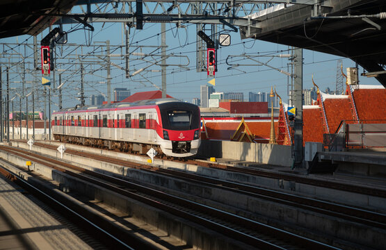 Bangkok, Thailand-August 19, 2023: Train of the State Railway of Thailand (SRT) red line service arriving at Wat Samien Nari station.