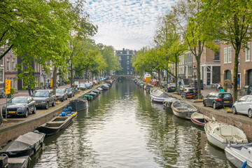 Fototapeta na wymiar Cars and Boats on the Amsterdam Canal