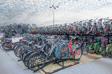 Fototapeta na wymiar Lots of Bicycles on Bike Parking in Amsterdam