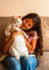 Fototapeta na wymiar Happy beautiful young woman holding her cute cat.