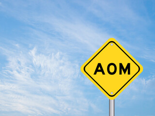 Yellow transportation sign with word AOM (Abbreviation of Advanced order management, add on module or assistant operation manager) on blue color sky background