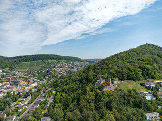 Aerial view from Swiss City of Baden with village, mountain panorama  and woodland on a sunny summer noon. Photo taken August 19th, 2023, Baden, Canton Aargau, Switzerland.