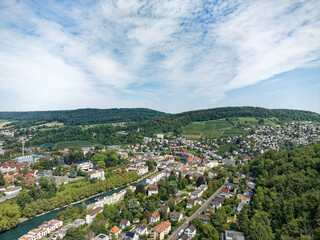 Aerial view of Swiss City of Baden with Industrial district, Limmat River and bridge on a sunny summer noon. Photo taken August 19th, 2023, Baden, Canton Aargau, Switzerland.