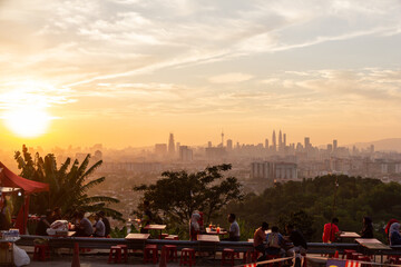 Fototapeta premium Kuala Lumpur skyline sunset enjoyed by anonymised friends and couples