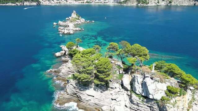 Church on the rock on Katic islet in Petrovac na Moru Aerial View. Beaches and coastline of the Adriatic Sea at summer time. Natural landscapes of Montenegro. Balkans. Europe.