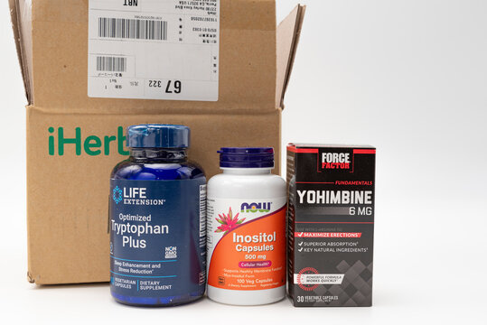 Fuji, Shizuoka, Japan - March 21, 2023: Cardboard box from iHerb online store with supplements: Tryptophan Plus, Inositol 500 mg and Yohimbine 6 mg. Isolated on White Background