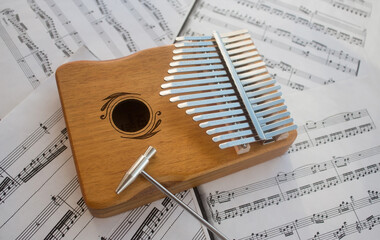 Musical instrument kalimba on the background of notes