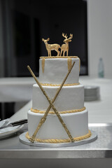 Two rendeer wedding cake toppers with magig sticks and gold elements Harry Potter style