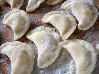 Fresh ravioli handmade cooking on wooden desk. And ricotta ravioli, top view