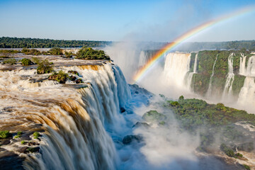 Perfect rainbow over Iguazu Waterfalls, one of the new seven natural wonders of the world in all its beauty viewed from the Brazilian side - traveling South America