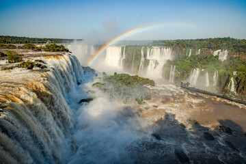 Perfect rainbow over Iguazu Waterfalls, one of the new seven natural wonders of the world in all its beauty viewed from the Brazilian side - traveling South America