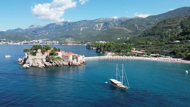 Island of Sveti Stefan near Budva in Montenegro. Beaches and coastline of the Adriatic Sea at summer time. Natural landscapes of Montenegro. Balkans. Europe.