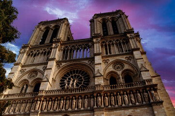 Fototapeta na wymiar The imposing front of Notre Dame Cathedral in Paris with a dramatic sky.