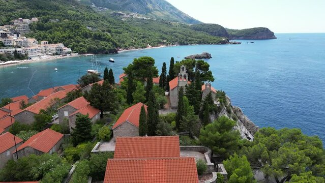 Island of Sveti Stefan near Budva in Montenegro. Beaches and coastline of the Adriatic Sea at summer time. Natural landscapes of Montenegro. Balkans. Europe.