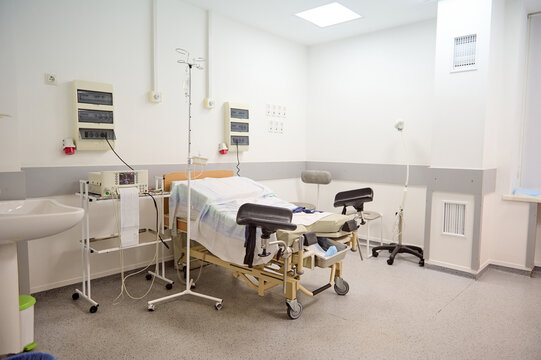 Empty Delivery Room With Bed And Medical Equipment In Maternity Ward At Hospital. Childbirth. Delivery. Labor Concept