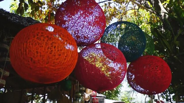colorful huge Christmas balls made of abaca fiber hung in a store front
