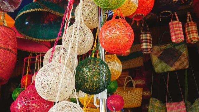 colorful huge Christmas balls made of abaca fiber hung in a store front