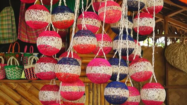 colorful huge Christmas balls made of abaca fiber hung in a store front