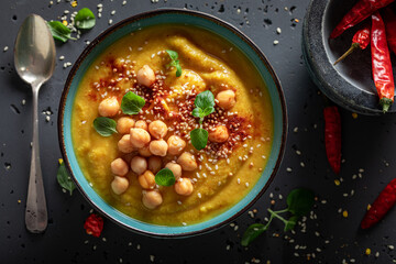 Green chickpea soup with hot chilli pepper and sesame seeds.