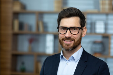 Close-up portrait of mature adult experienced businessman, boss smiling and looking at camera...