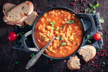 Tasty minestrone soup with noodles and cherry tomatoes. - obrazy, fototapety, plakaty