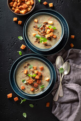Vegan mushrooms soup with champignons and croutons.