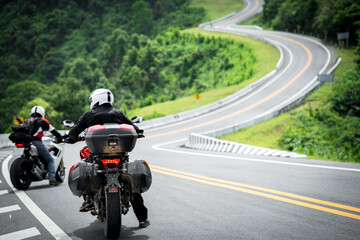 motorcycle on the road rides away. Travel on vacation, enjoy the nature trail. motorcycle in a...