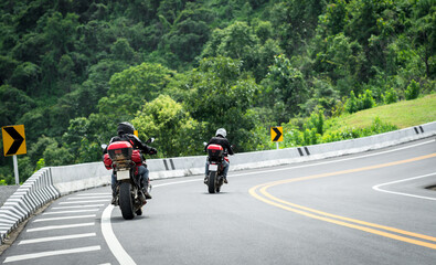 Obraz premium motorcycle on the road rides away. Travel on vacation, enjoy the nature trail. motorcycle in a sunny motorbike on the road riding.with sunset light. copyspace for your individual text.