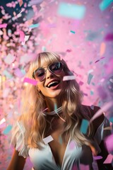 A joyous woman celebrates in style with magenta sunglasses, pink clothing, and a flurry of confetti surrounding her