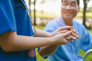 Female Doctor Touching Hand of the Senior Patient to Give Encouragement while Maintaining Physical Health Rehabilitation. Science of Touch. Selective Focus on Hands.