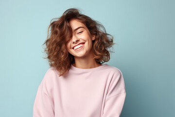 Fototapeta premium Happiness European Woman In Gray Sweatshirt On Pastel Background