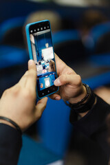 Student taking a photo while attending a lecture