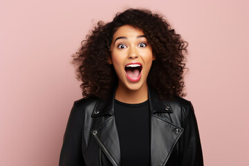 Surprise African Woman In Black Jacket On Pastel Background