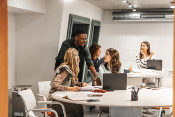 Diverse team of people discussing about a project in the office