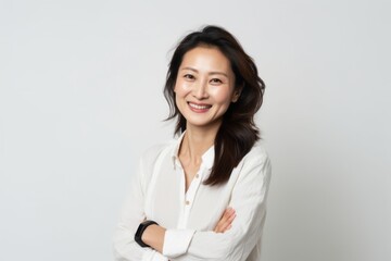 Medium shot portrait of a Chinese woman in her 30s in a white background wearing a chic cardigan