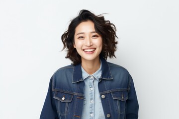 Medium shot portrait of a Chinese woman in her 30s in a white background wearing a denim jacket