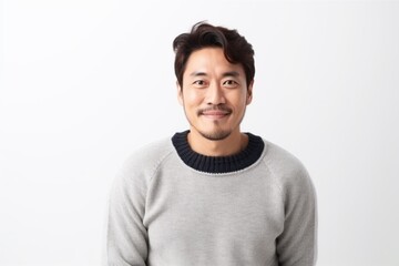Obraz premium Medium shot portrait of a Chinese man in his 30s in a white background wearing a cozy sweater