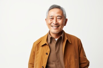 Portrait of a smiling senior asian man looking at camera over white background