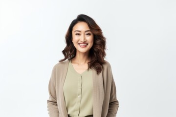 Obraz premium Portrait of a smiling young asian businesswoman standing over white background
