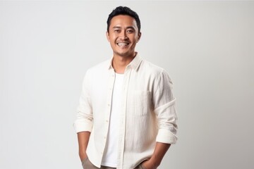Fototapeta premium Portrait of a smiling young asian man isolated on a white background