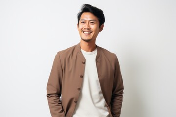 Fototapeta premium Portrait of a happy young asian man standing on white background